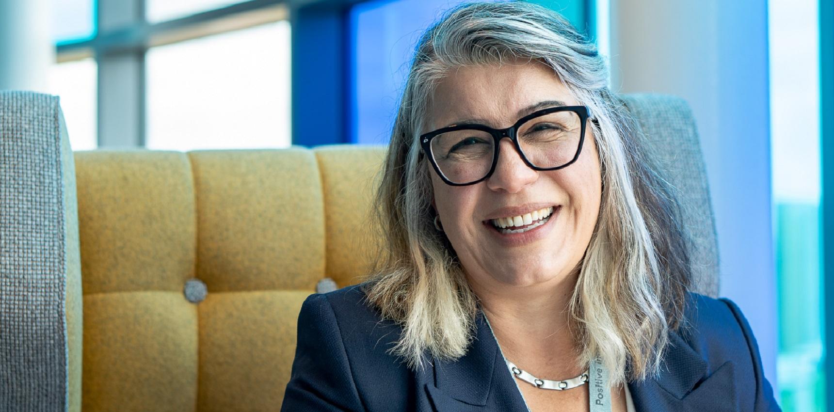 Head shot of a woman in an office situation